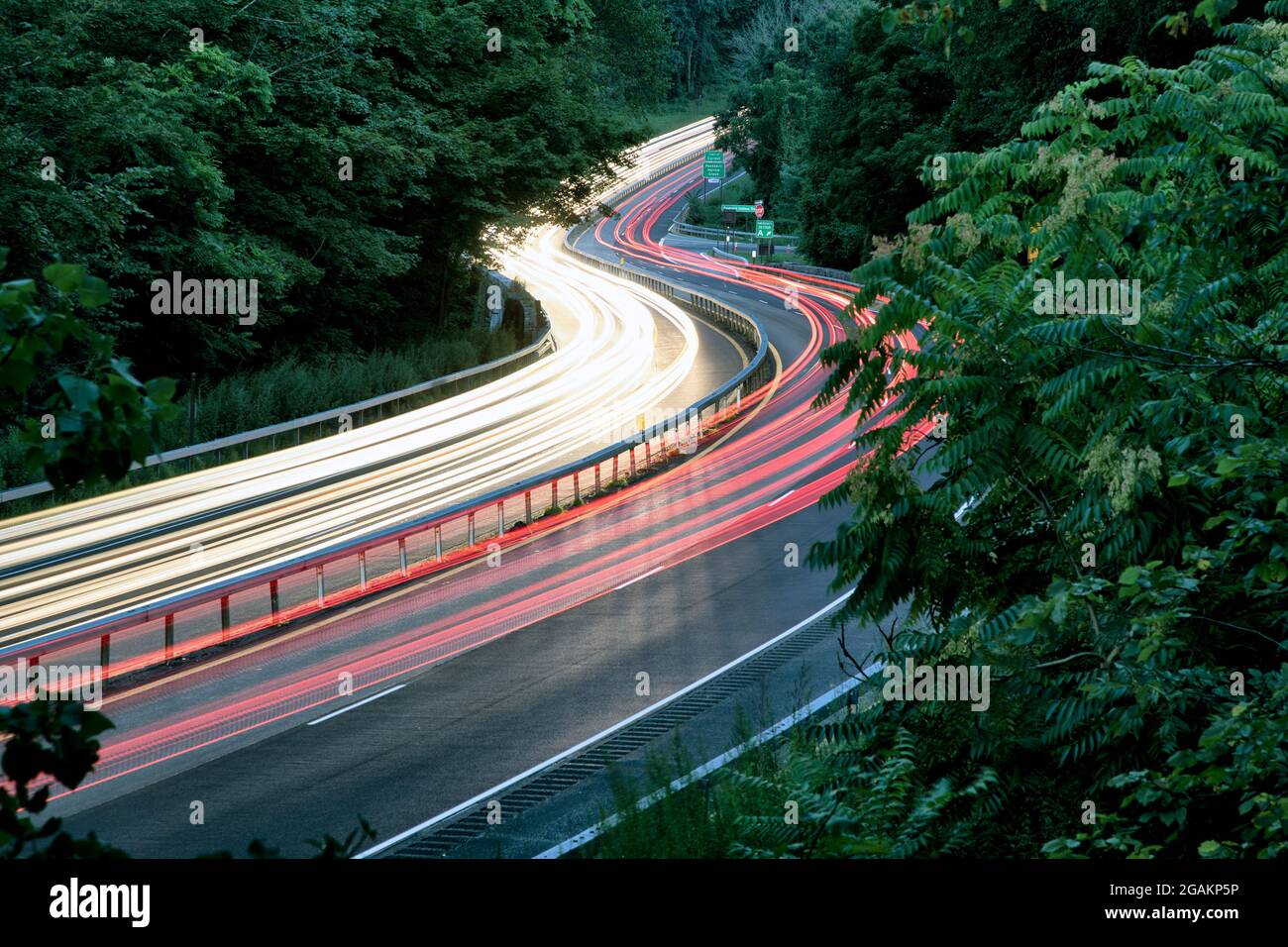 Rush hour traffic blurred by a slow camera shutter speed on the Taconic State Parkway in Putnam County, New York. Stock Photo