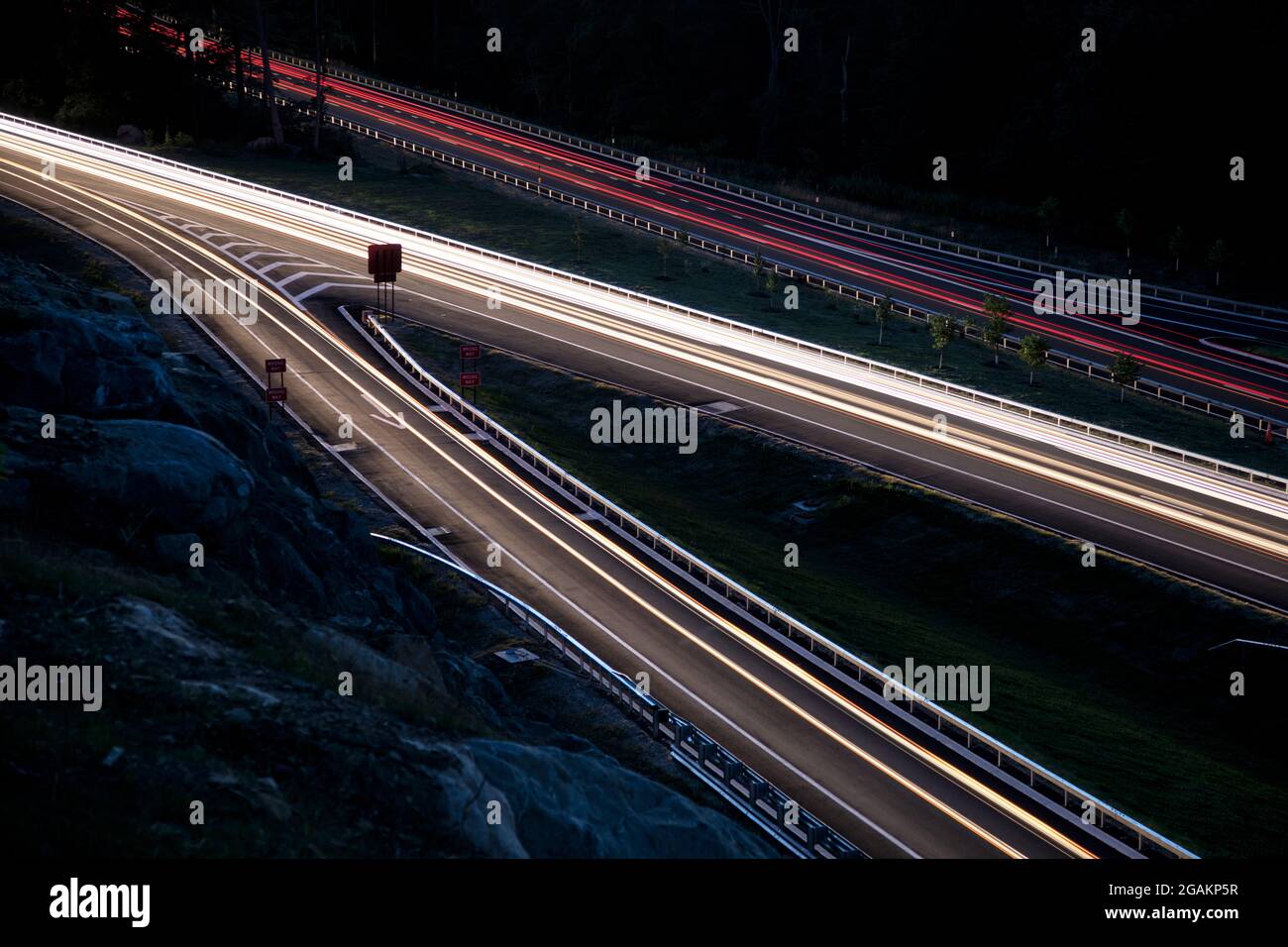New Pudding Street exit on the Taconic State Parkway at dusk. Rush hour traffic forms light streaks with the slow camera shutter speed. Stock Photo