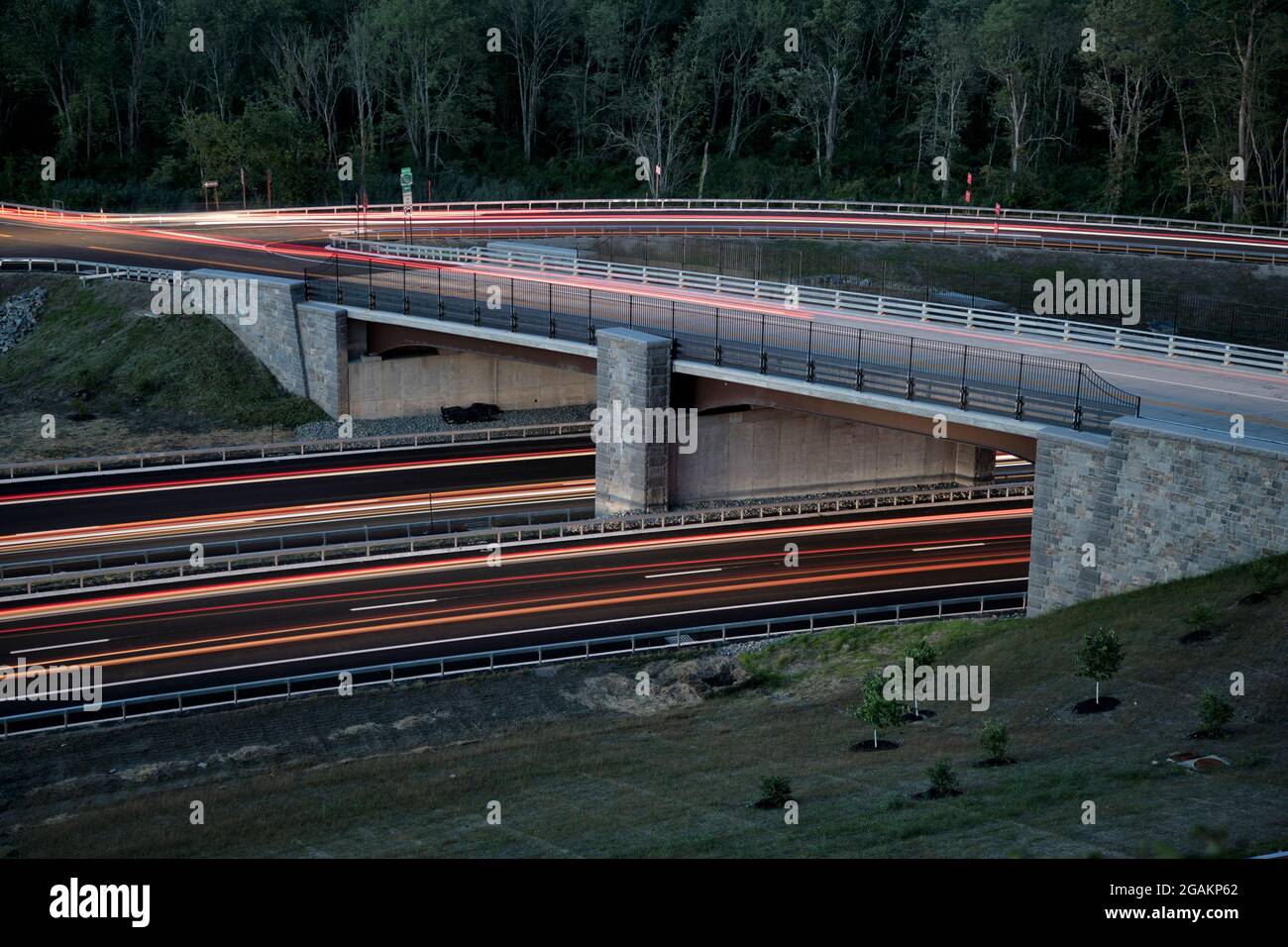 The new Pudding Street overpass on the Taconic State Parkway in Putnam County, New York. A slow camera shutter speed causes the car lights to streak. Stock Photo