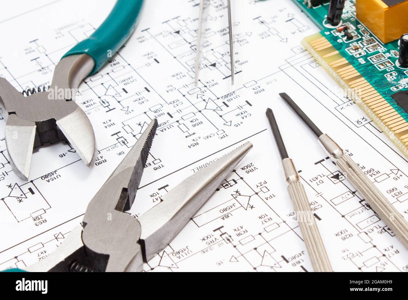 Printed circuit board with transistors, resistors, capacitor. Precision tools and diagram of