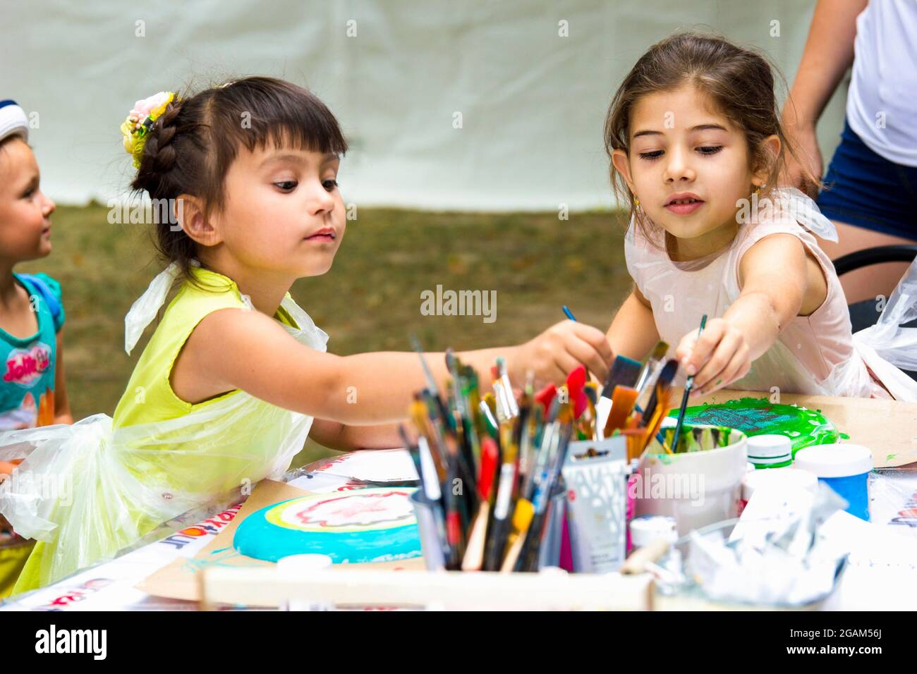 Moscow, Russia- August 12, 2018: Two girls learn to paint at the master class lesson. Stock Photo