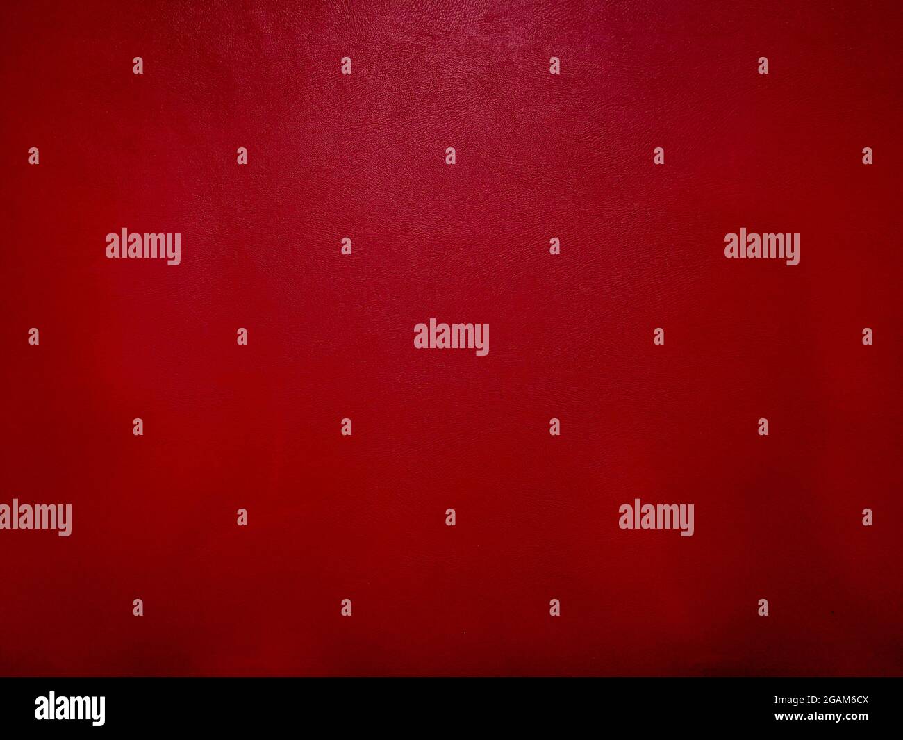 Dark red leather background with empty copy space. Dark red leather texture. Stock Photo