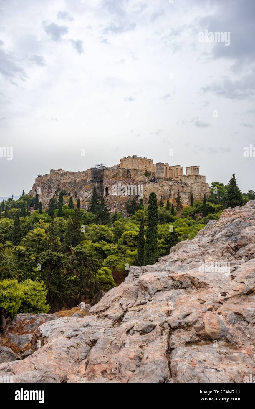 Acropolis (Parthenon, Propylaea, Temple of Athena Nike, Hekatompedon Temple) in summer greenery, Athens ancient historical landmark in city center wit Stock Photo