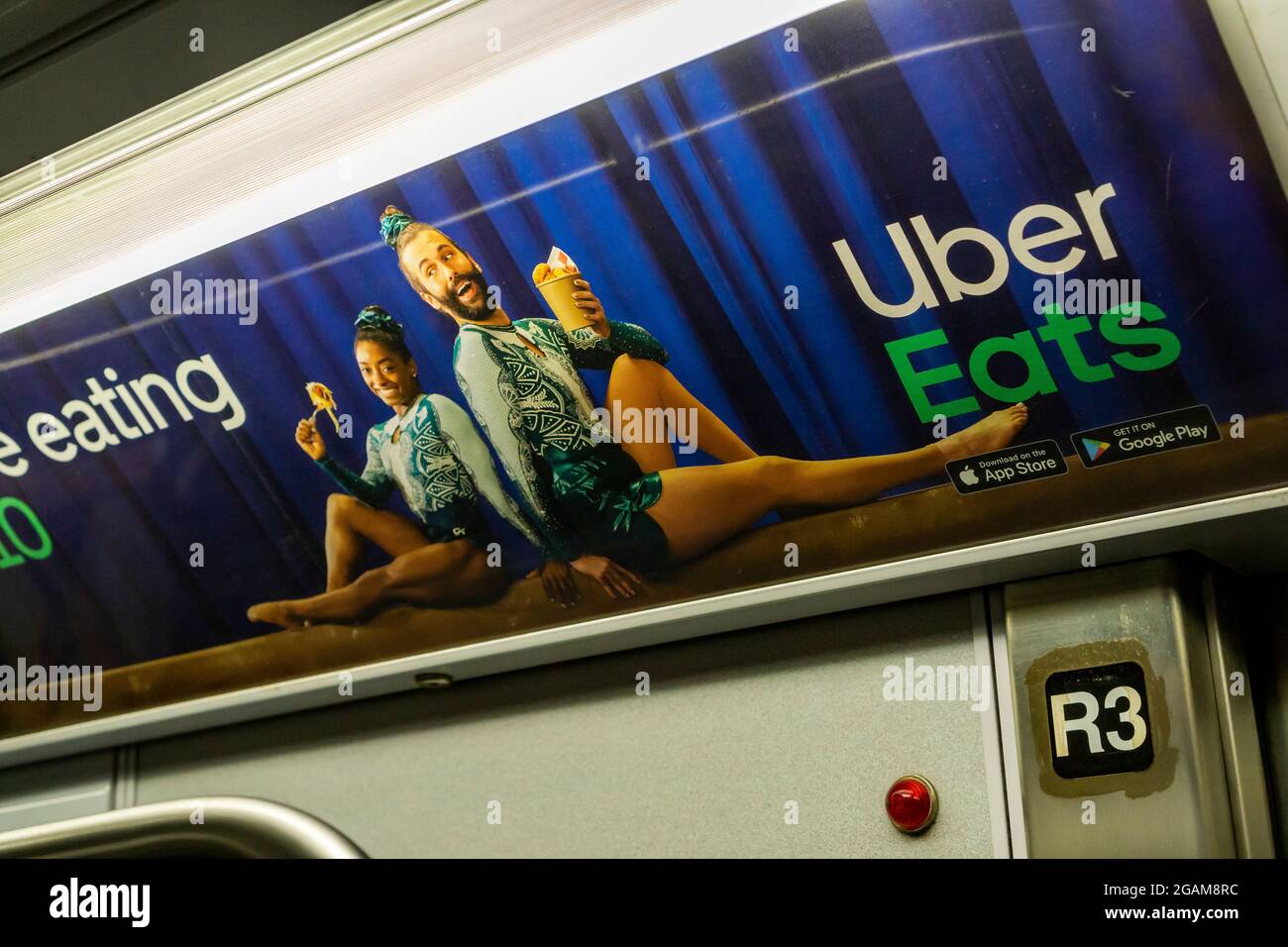 An advertisement for Uber Eats featuring gymnast Simone Biles, left, with amateur gymnast Jonathan Van Ness, in the subway in New York on Thursday, July 29, 2021. Uber Eats and the many other sponsors of Biles’ expressed their support for her after her decision to pull out of the individual, all-around gymnastics competition at the Tokyo Olympics.(© Richard B. Levine) Stock Photo