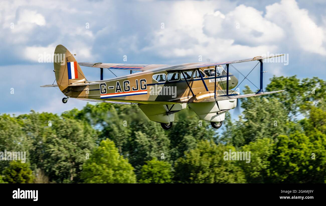1941 de Havilland DH-89A Dominie/Dragon Rapide ‘G-AGJG’ airborne at Shuttleworth Flying Festival of Britain airshow on the 6th June 2021 Stock Photo