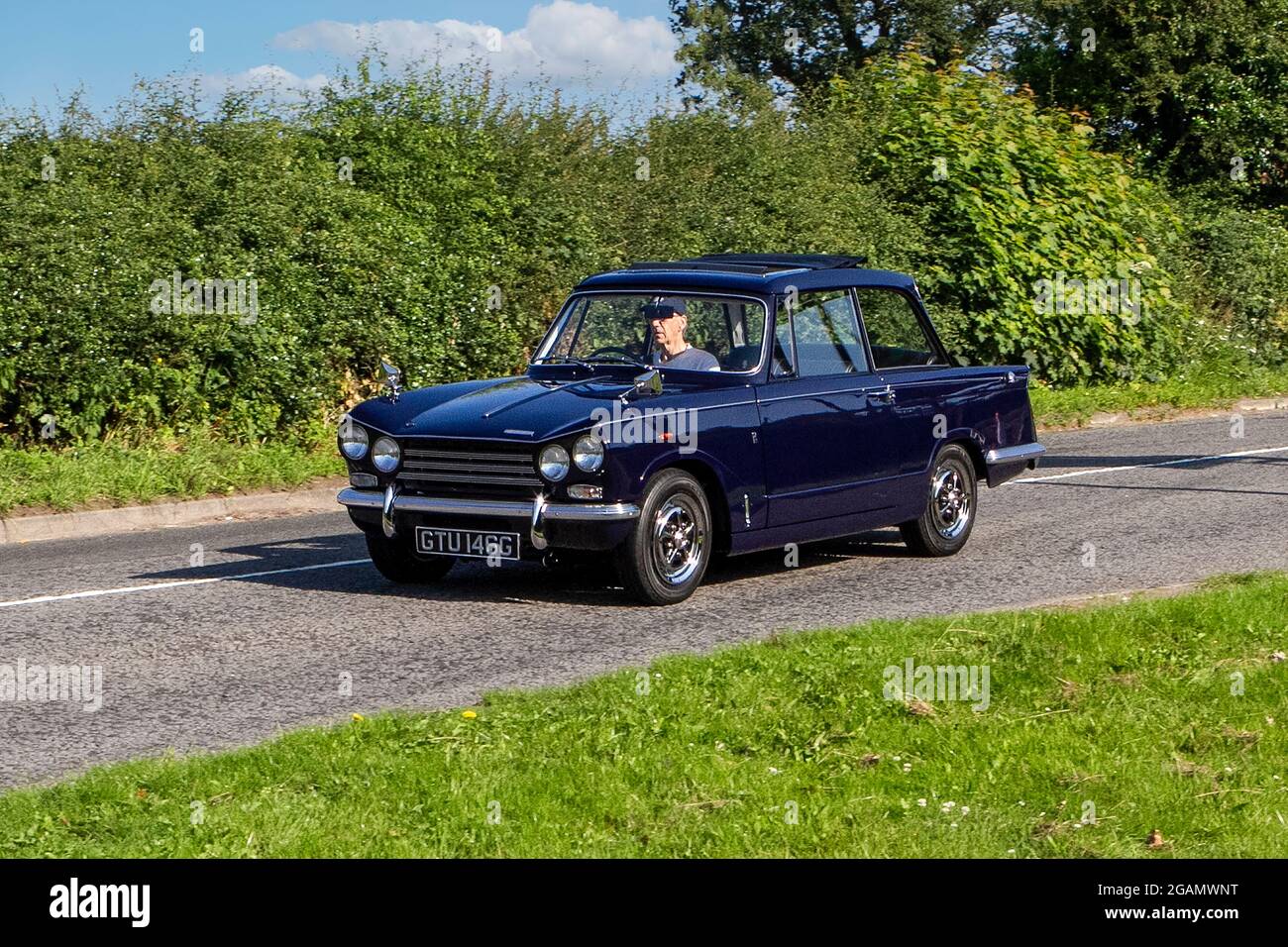 A 1968 60s Triumph VITESSE petrol classic vintage car arriving at the Capesthorne Hall classic car show. Stock Photo