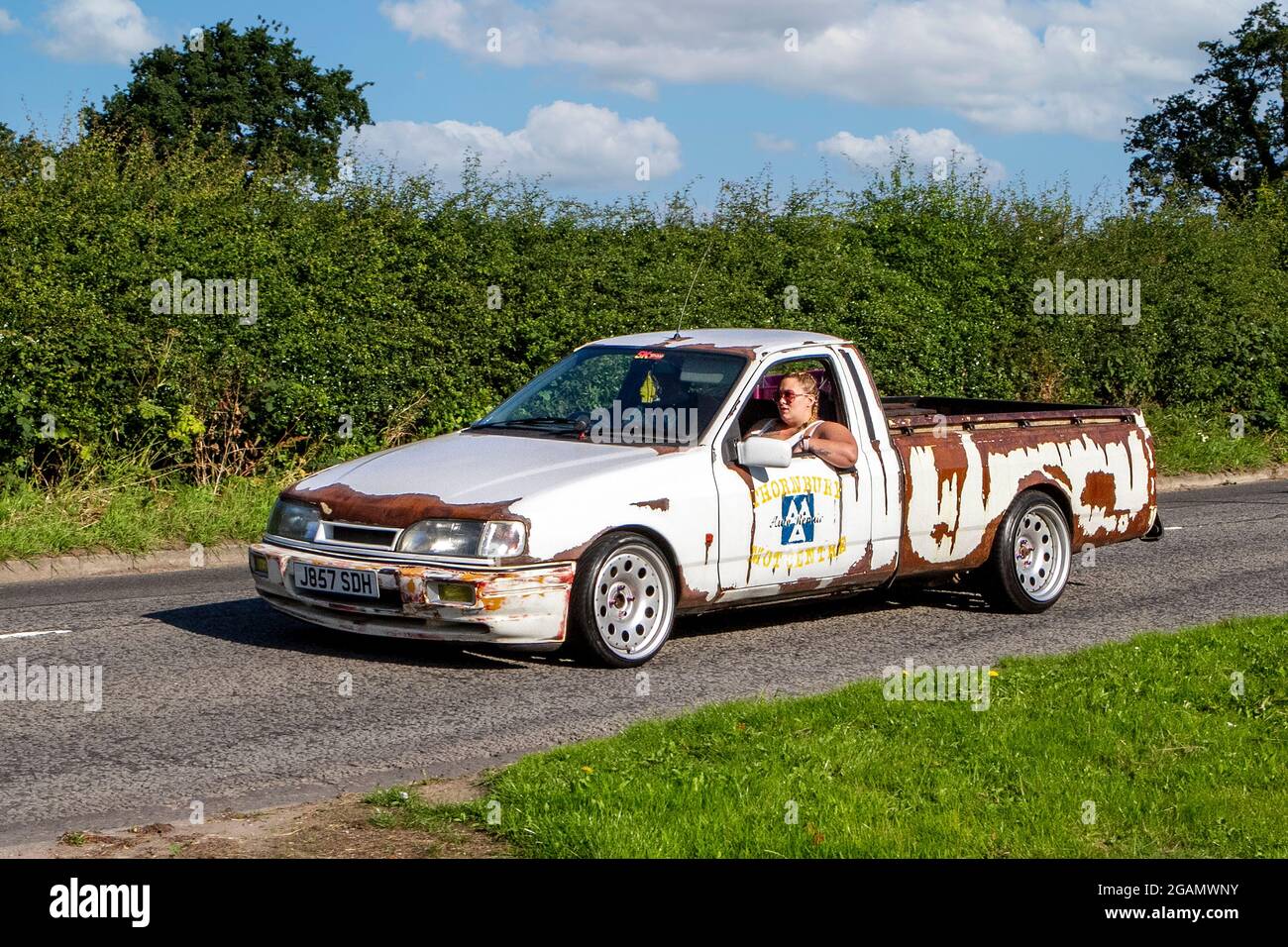1991, 90s, 1990s, rusty white Ford Popular pick-up classic vintage car arriving at the Capesthorne Hall classic car show. Stock Photo