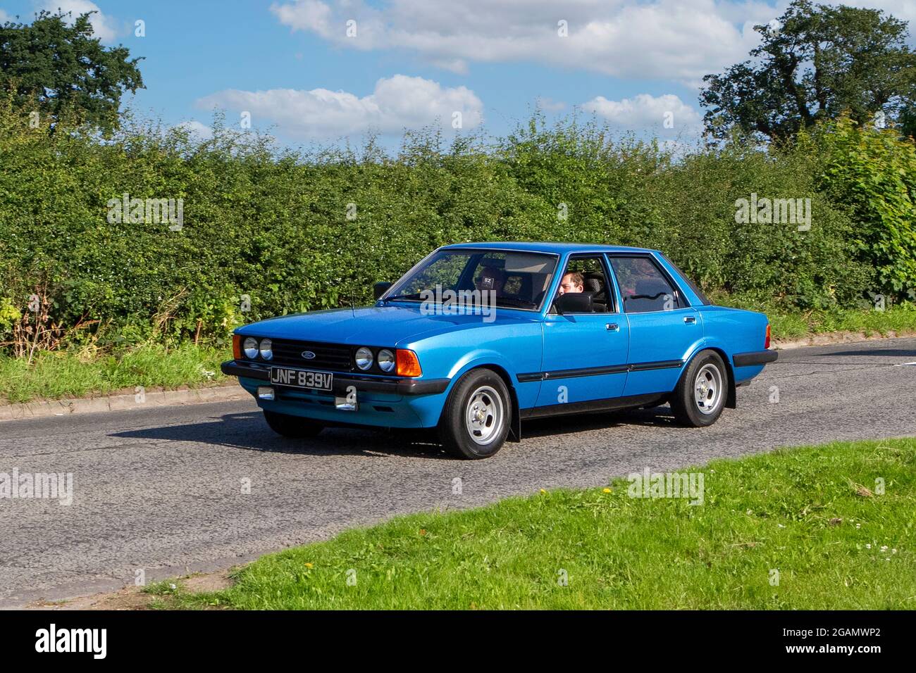 A 1980 80s Ford Cortina Gl Blue classic vintage car arriving at the Capesthorne Hall classic car show. Stock Photo