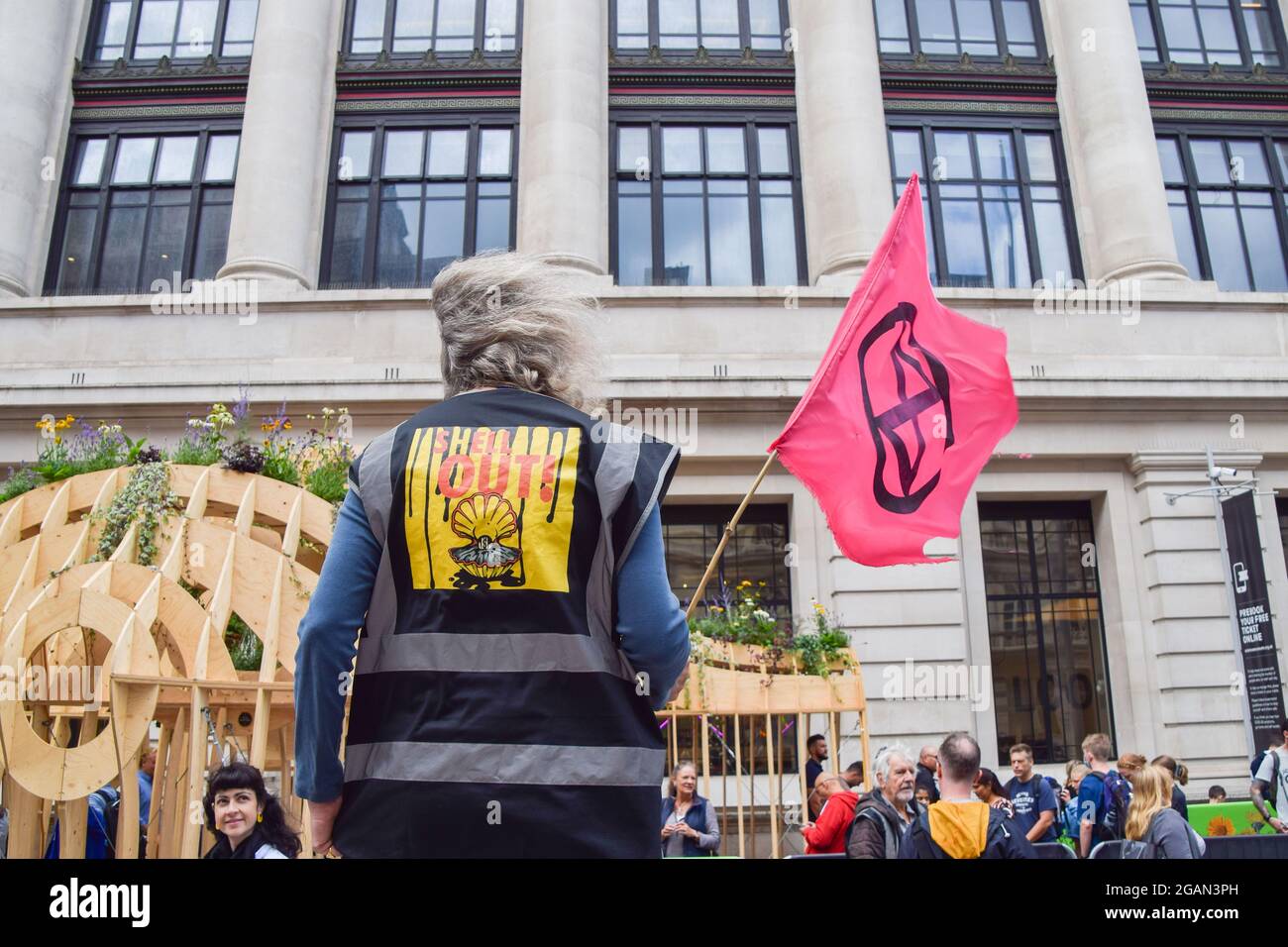 A demonstrator holds an Extinction Rebellion flag outside the Science ...