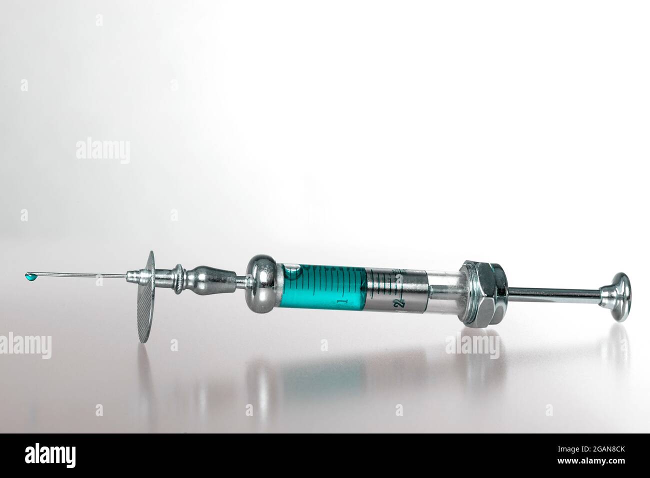 Studio shot of an old syringe filled with toxic looking liquid Stock Photo