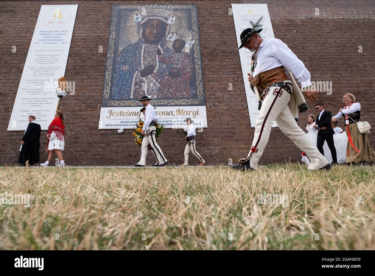 Czestochowa, Poland. 31st July, 2021. Highlanders walking past a huge image  of Mother Mary, during the pilgrimage.Every year in summer, thousands of  pilgrims come to Jasna Gora Monastery in Czestochowa to pray