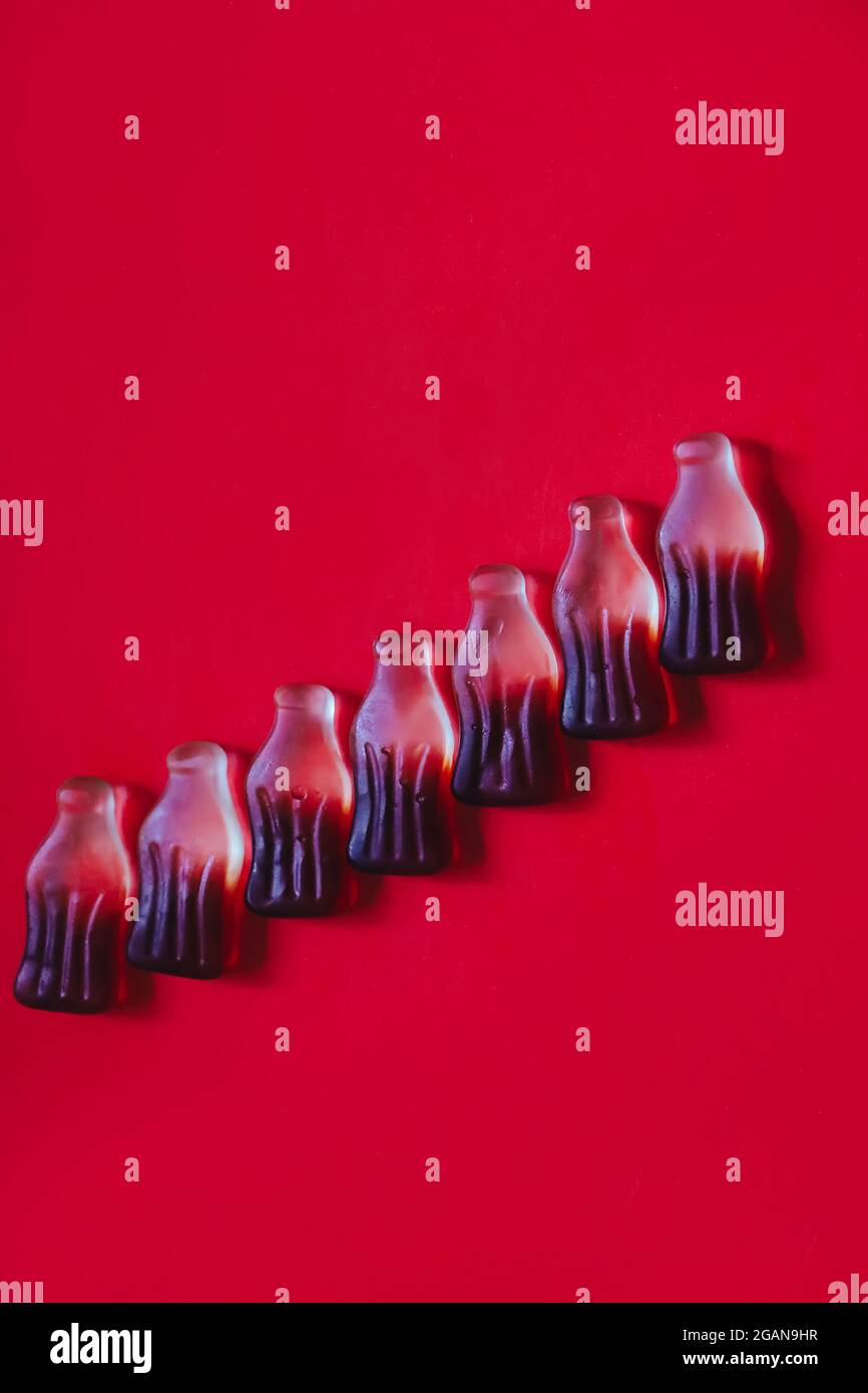 Gummy jelly candies in row in cola bottles shape and flavour Stock