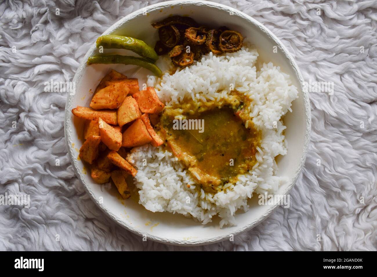 Tasty and simple Indian thaali dish of rice, Dal, potato curry, and ...