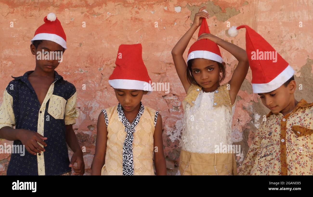 Group of Indian kids wearing Santa hats Stock Photo - Alamy