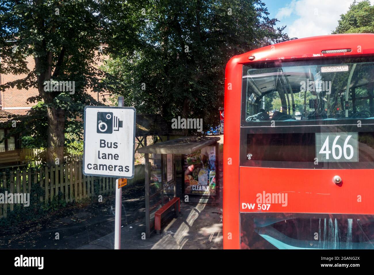 Bus lane camera board and a Red London bus in frame Stock Photo