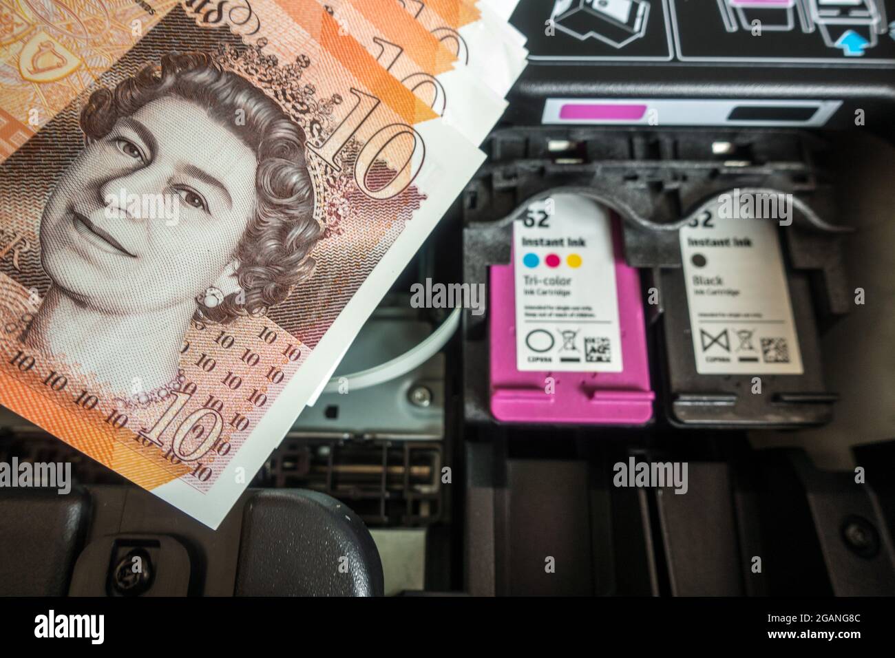 Expensive printer ink cartridge concept with currency in foreground