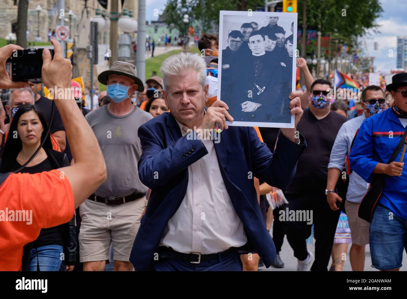 Charlie Angus, Federal MP  holding a picture of Father Arthur Lavoie, Oblate priest at March for Truth and Justice for Canadian Indigenous People Stock Photo