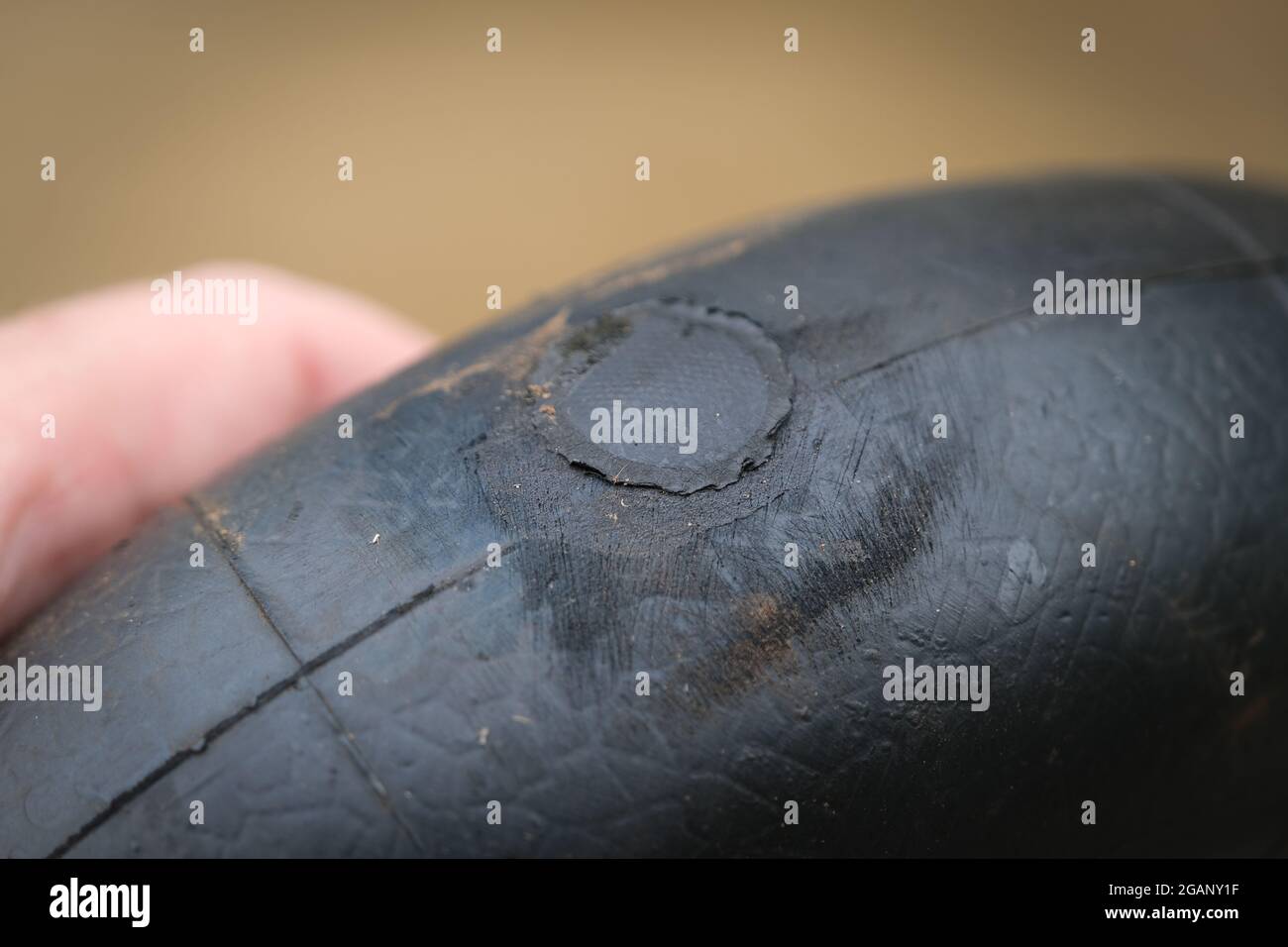 A patch glued to a tyre tubing to repair a puncture. Stock Photo