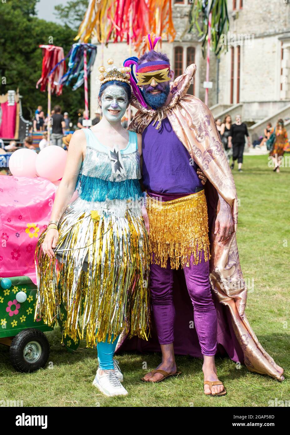 Lulworth, Dorset UK, Saturday, 31st July 2021 A couple wear Troll The Movie  fancy dress on