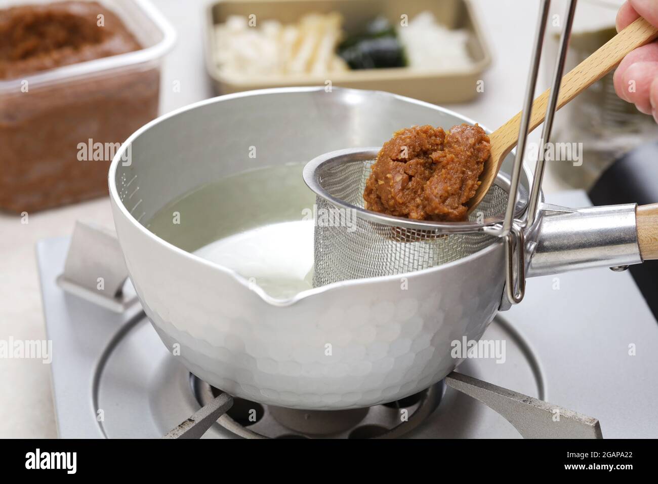 How to make Japanese miso soup.  Add miso paste Stock Photo