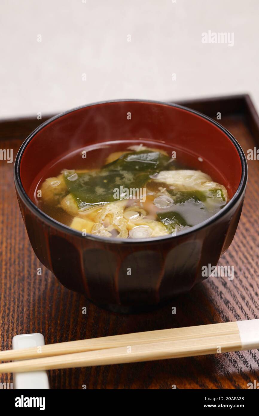 Japanese miso soup, additional ingredients such as green onion, wakame seaweed, and fried tofu. Stock Photo