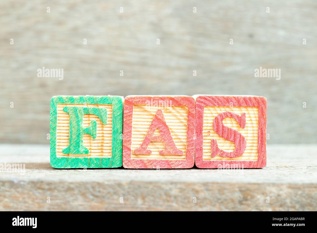 Color alphabet letter block in word FAS (Abbreviation of Fetal alcohol syndrome, Free alongside or Financial accounting standards) on wood background Stock Photo
