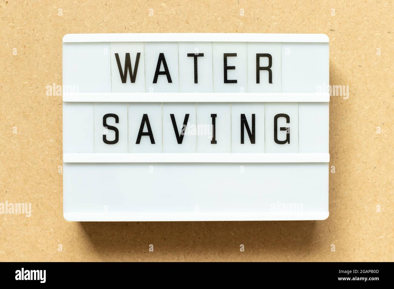 Lightbox with word water saving on wood background Stock Photo