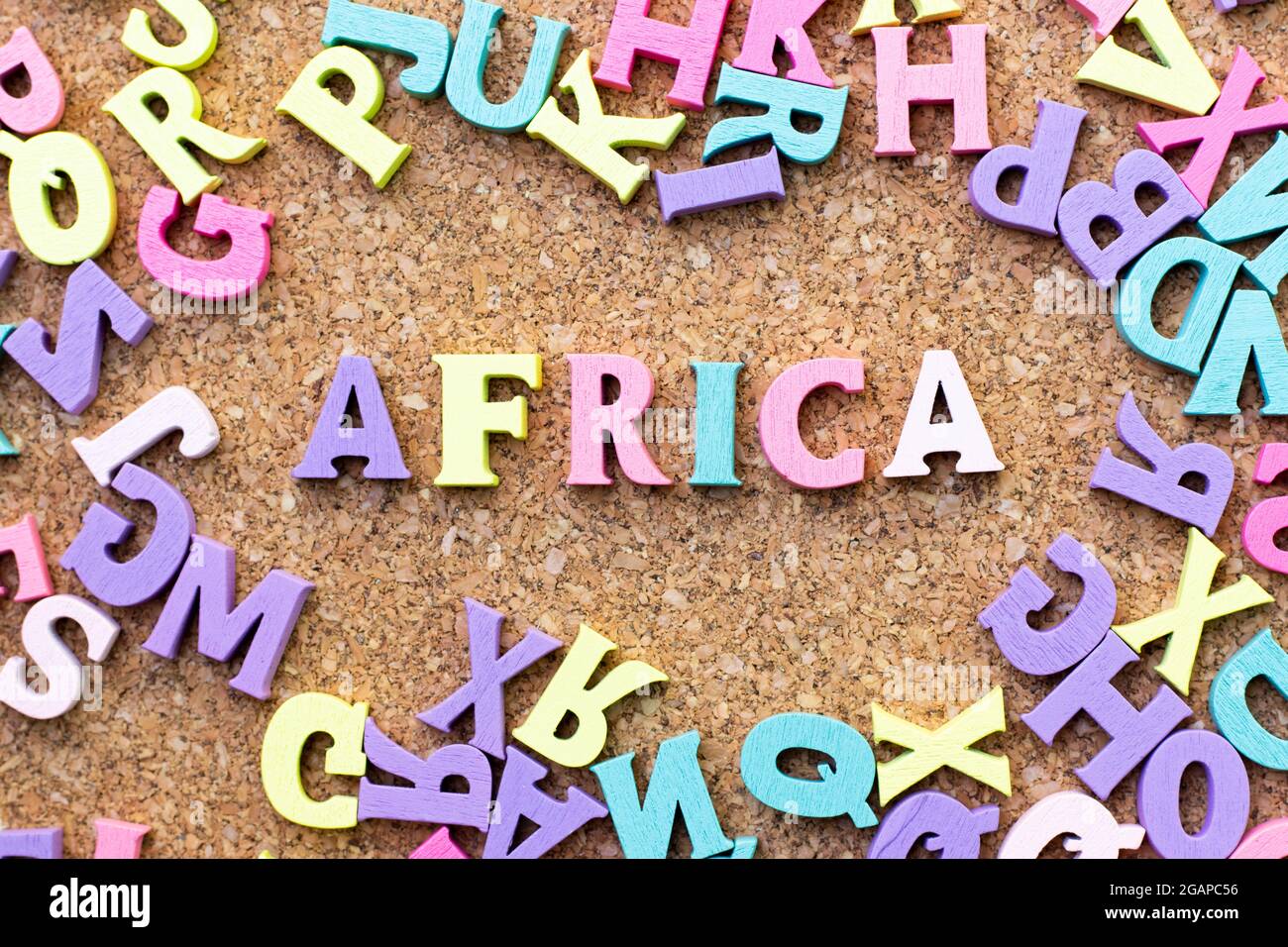 Color alphabet in word africa with another letter as frame on cork