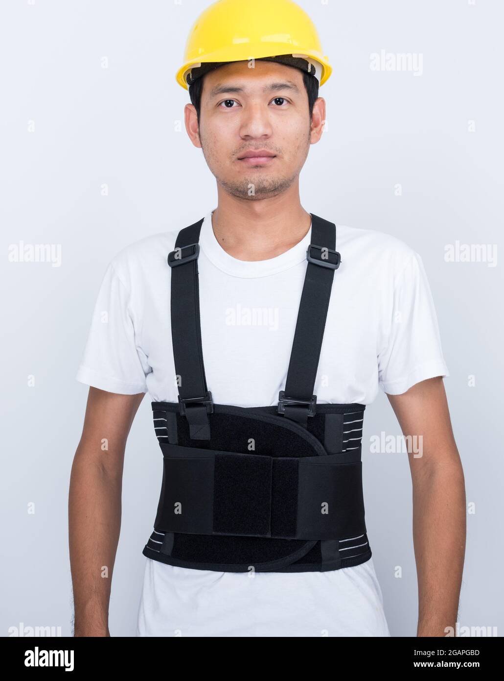 Worker Man stand wearing back support belt body protect posture Stock