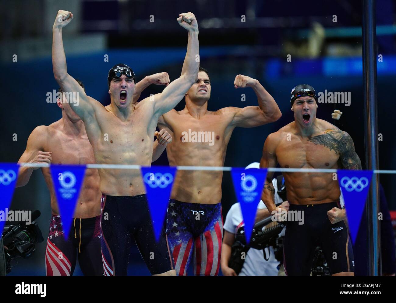 The USA team including Caeleb Dressel (right) celebrate winning gold ...