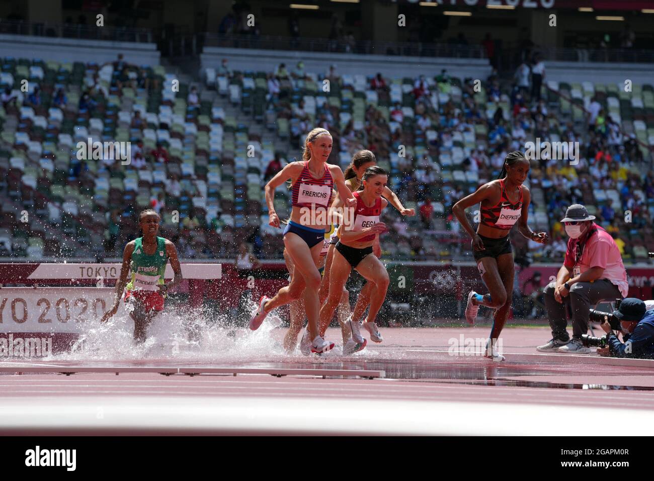 1st August 2021; Olympic Stadium, Tokyo, Japan: Tokyo 2020 Olympic summer games day 9; Womens 3000m steeplechase heats: GEGA Luiza of Albania and eventual winner FRERICHS Courtney of USA take the water jump as CHEPKOECH Beatrice of Kenya powers away Stock Photo