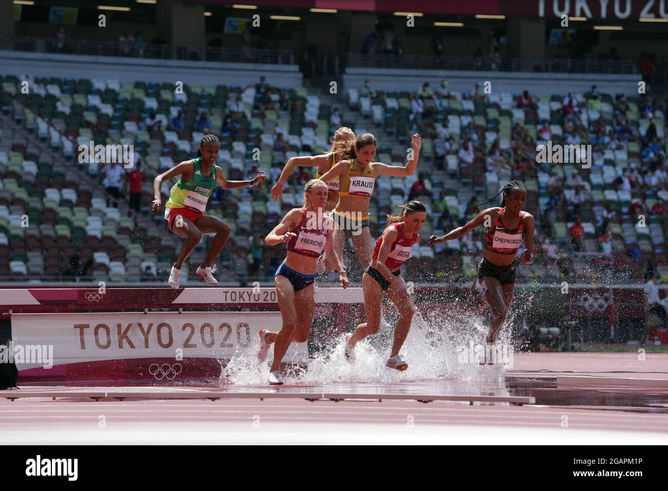 1st August 2021; Olympic Stadium, Tokyo, Japan: Tokyo 2020 Olympic summer games day 9; Womens 3000m steeplechase heats: GEGA Luiza of Albania and eventual winner FRERICHS Courtney of USA take the water jump as CHEPKOECH Beatrice of Kenya powers away Stock Photo