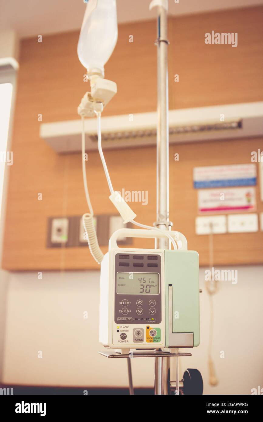 Infusion pump intravenous IV drip on hospital room blurred background
