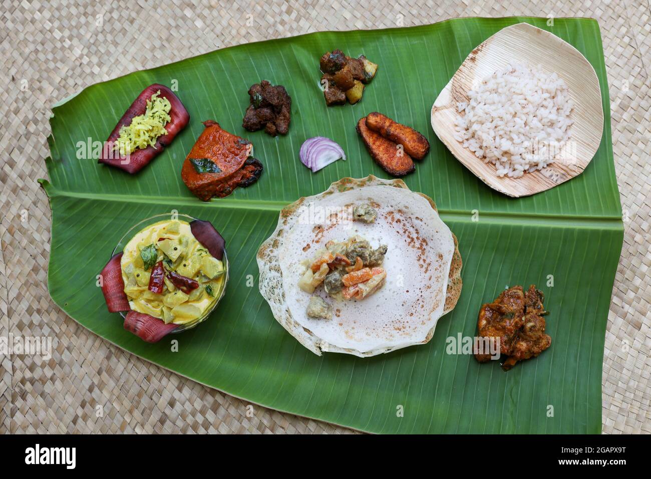 Appam, Hoppers and mutton stew Kerala breakfast food and Indian milk