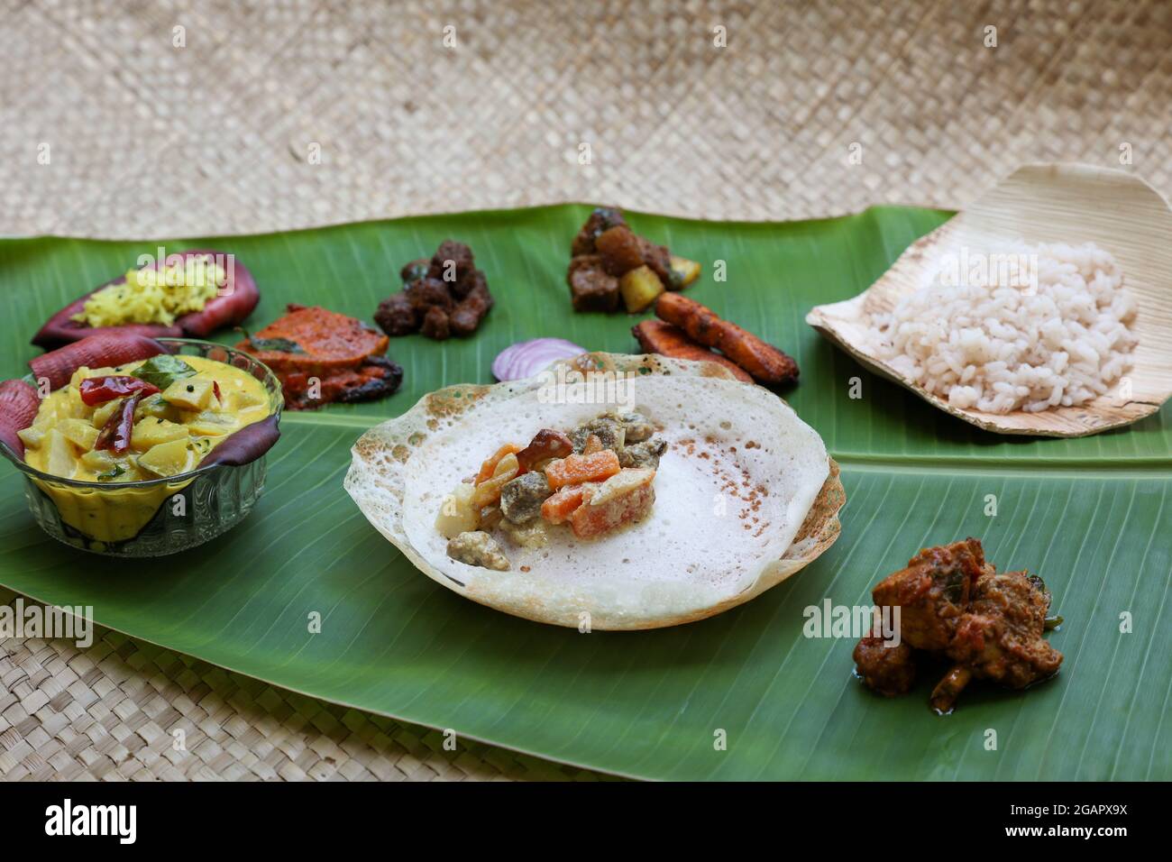 Appam, Hoppers and mutton stew Kerala breakfast food and Indian milk