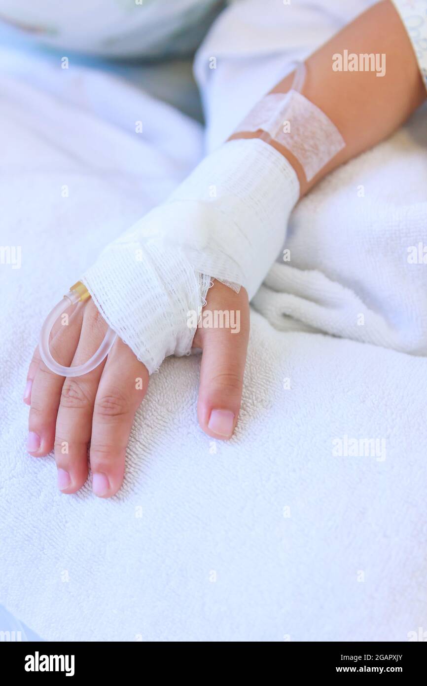 Iv In My Hand Close up of saline intravenous (iv) drip in a child's patient hand ...