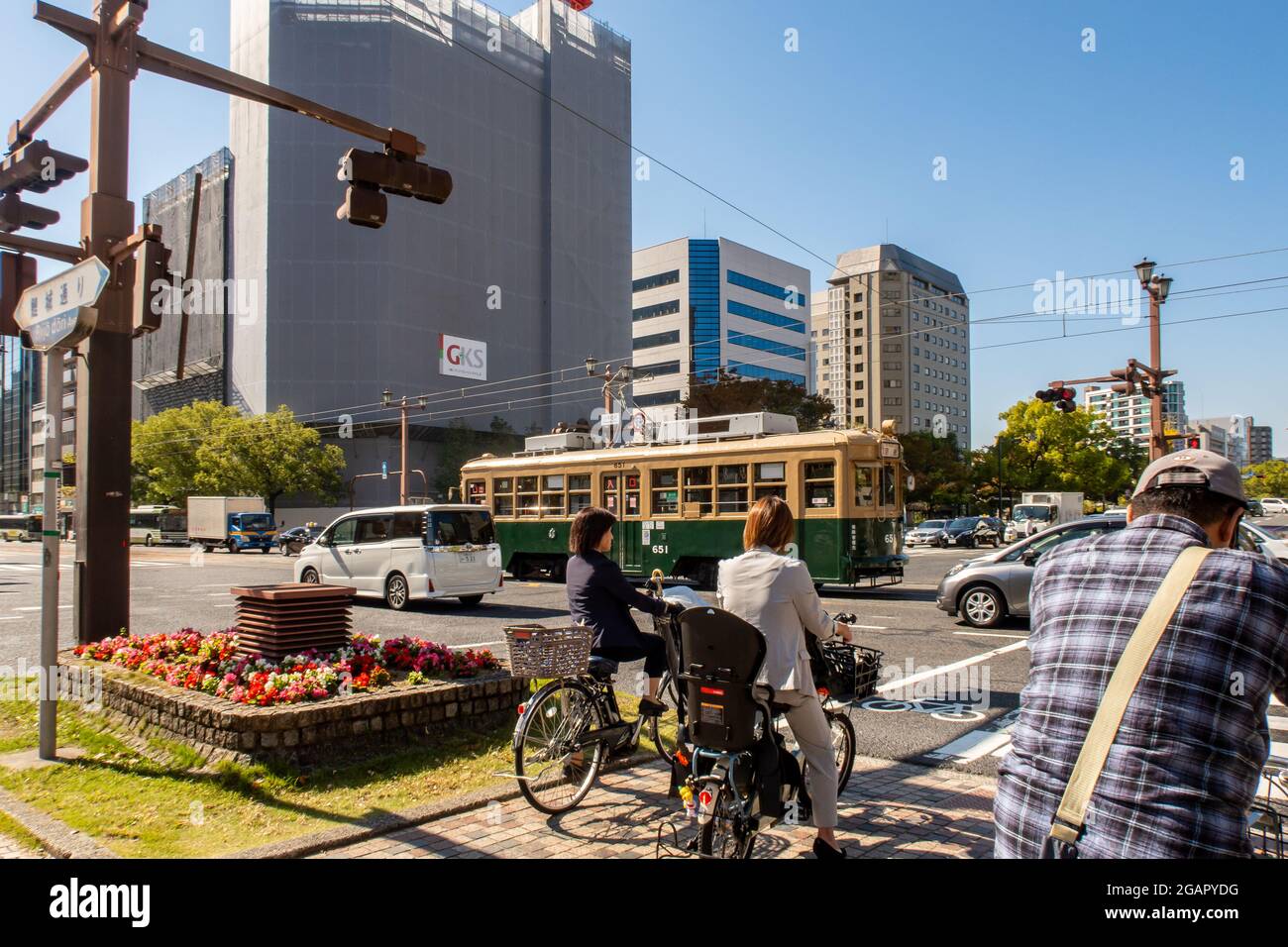 HIROSHIMA, Japan, 31.10.2019. Road intersection in Hiroshima with famous old green tram car no 651 which survived atomic bombing. Stock Photo