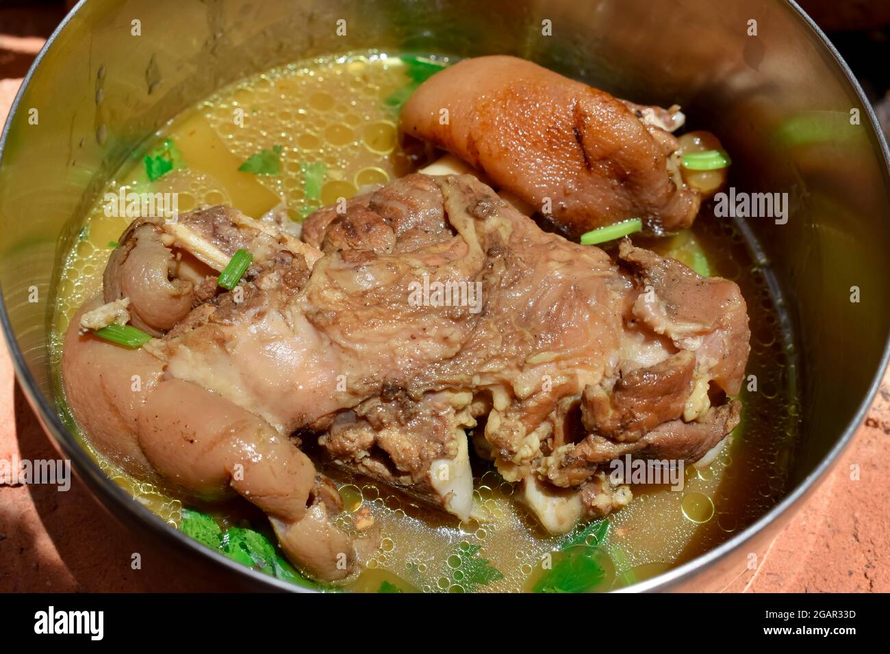 Myanmar or Burmese, Asian pork leg soup recipe in steel dish. Stock Photo
