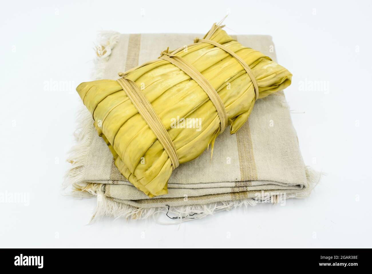 Myanmar or Burmese traditional street food, glutinous rice zongzi. Isolated on white background. Lateral view. Stock Photo