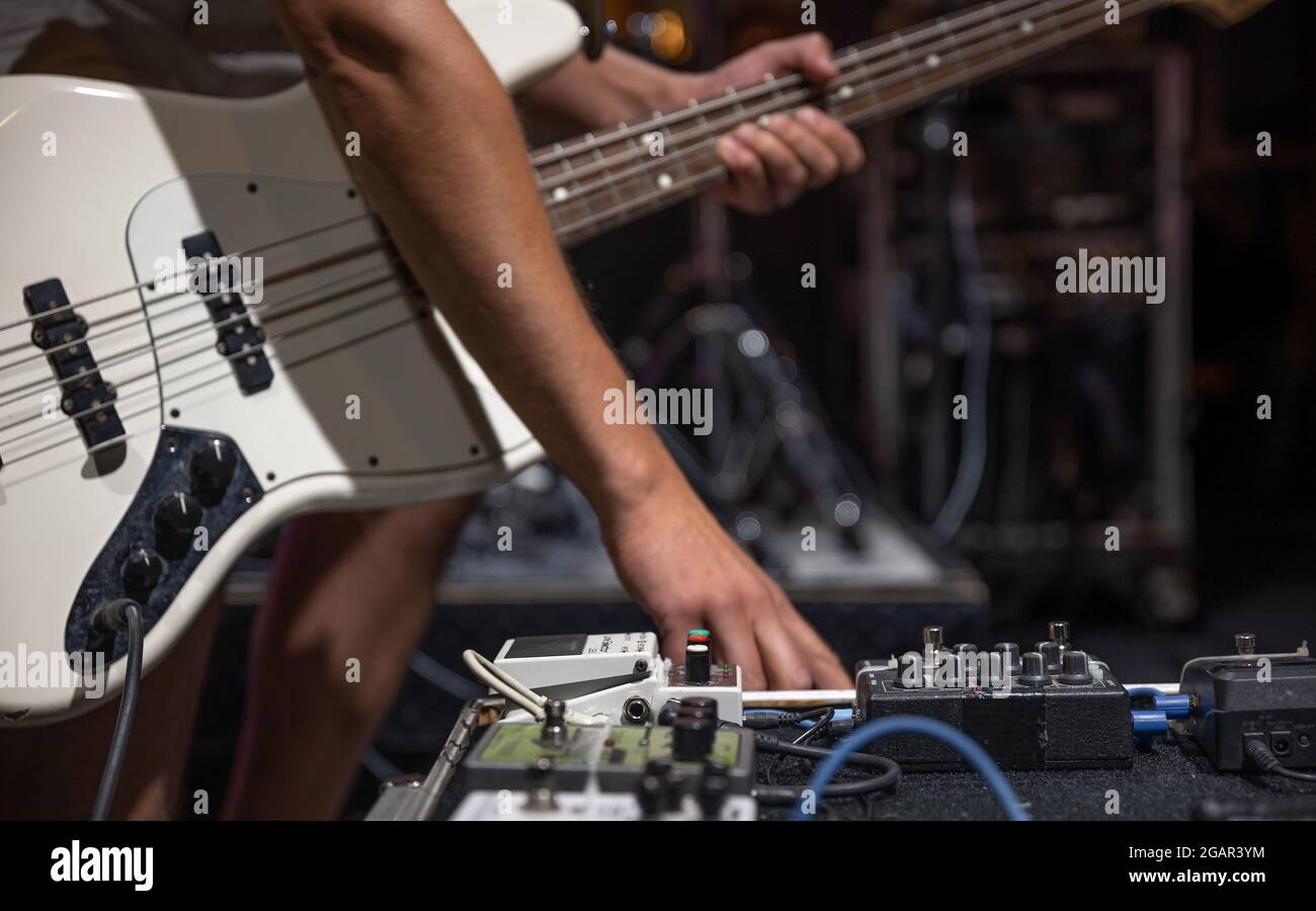 A male guitarist setting up guitar audio processing effects on stage Stock Photo Alamy