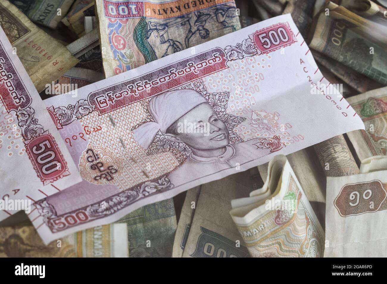 Heap of old Myanmar money. Stacks of Burmese banknotes. Burma currency. Stock Photo