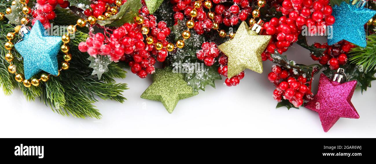 Christmas tree branch with red berries and decorations on white ...