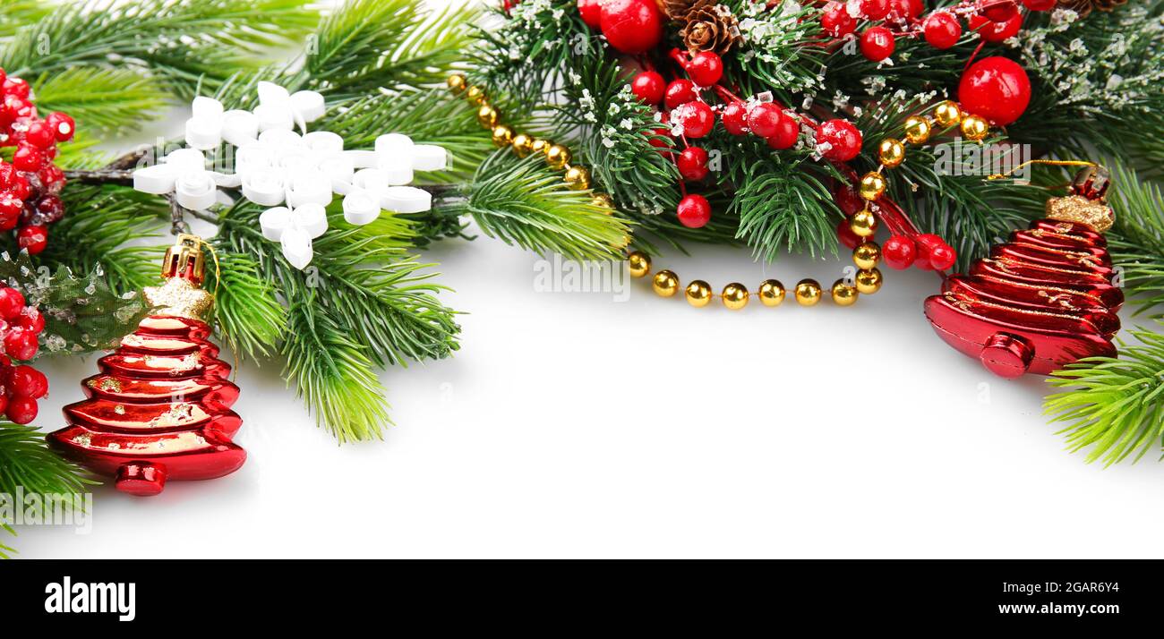 Christmas tree branch with red berries and decorations on white ...