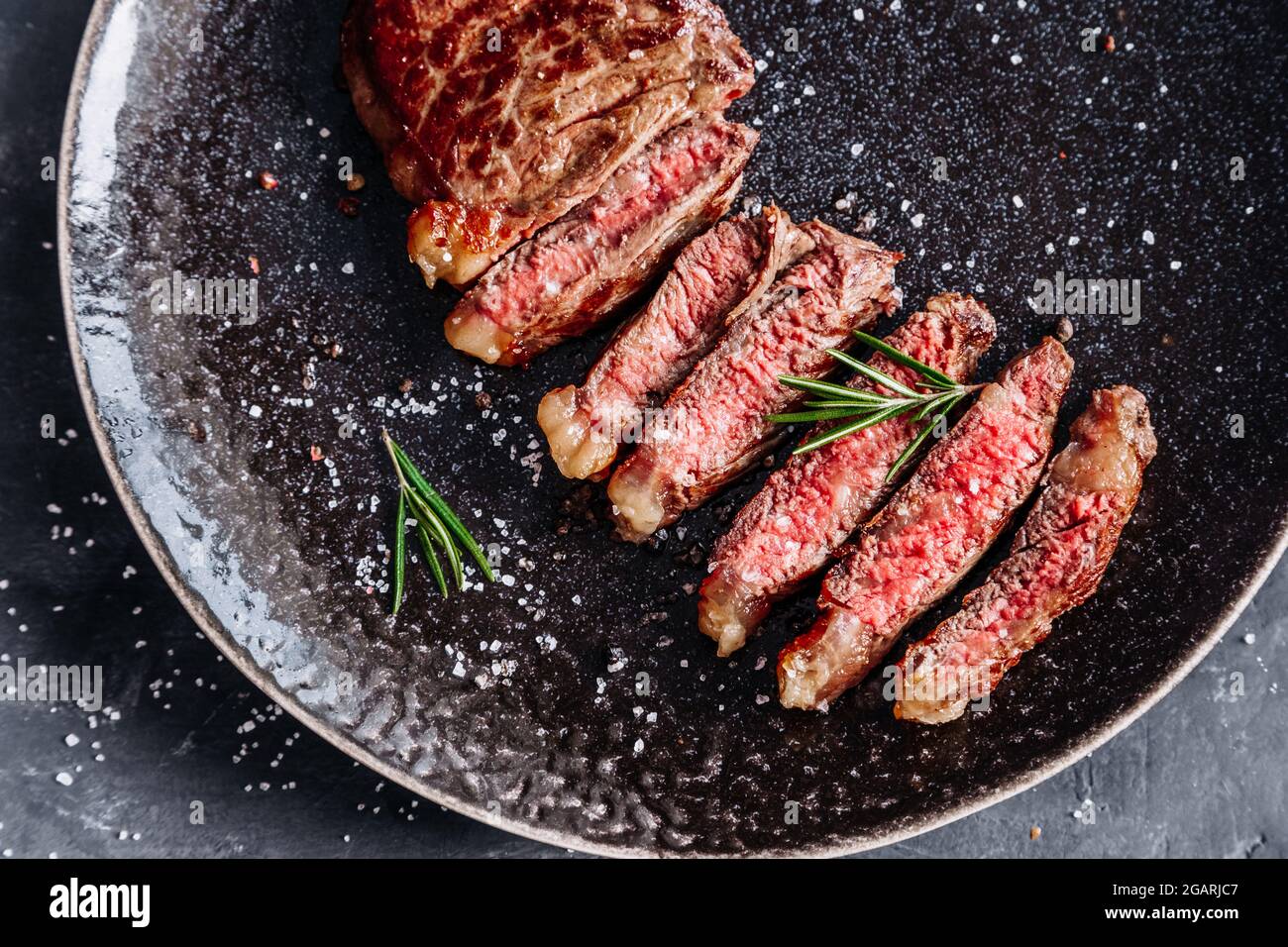 New York sirloin steak medium rare with rosemary top view Stock Photo