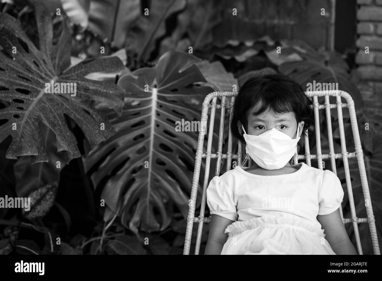 Little girl with mask Black and White Stock Photos & Images - Alamy