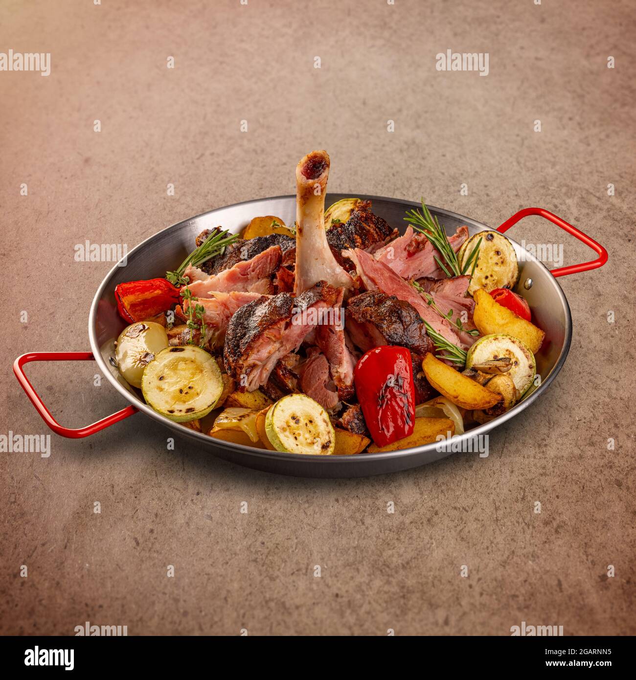 Crispy roasted pork knuckle served with roasted vegetables Stock Photo