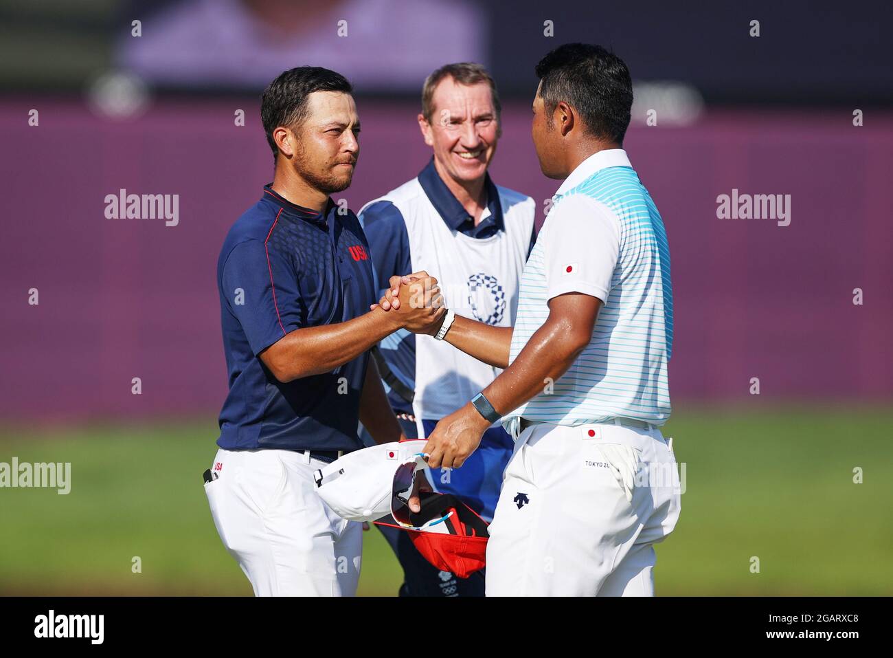 Saitama, Japan. 1st Aug, 2021. Xander Schauffele (L) of the United States greet his opponent after the men's individual stroke play round 4 golf match at Tokyo 2020 Olympics in Saitama, Japan, Aug. 1, 2021. Credit: Zheng Huansong/Xinhua/Alamy Live News Stock Photo