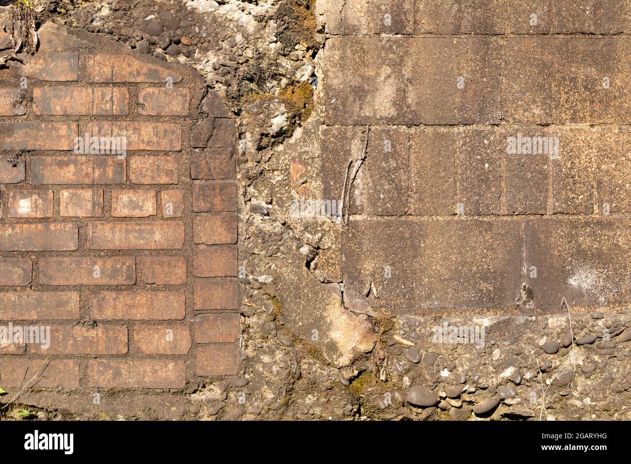 Wall with a wide variety of textures, brick, block, and concrete aggregate, grunge copy space, horizontal aspect Stock Photo