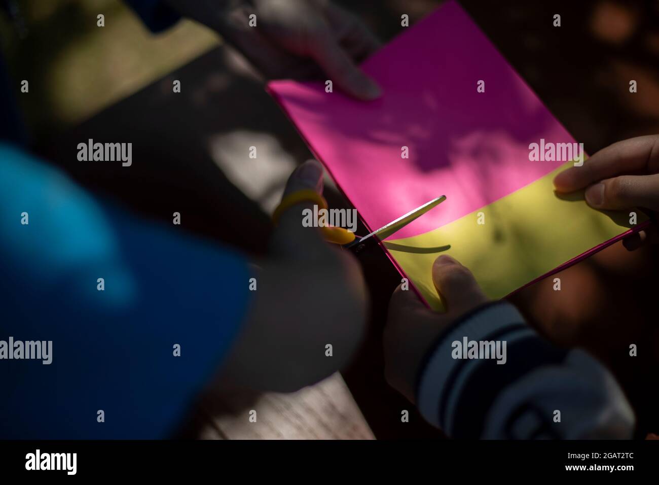 Cutting colored paper. Scissors cut the paper. Creativity with children