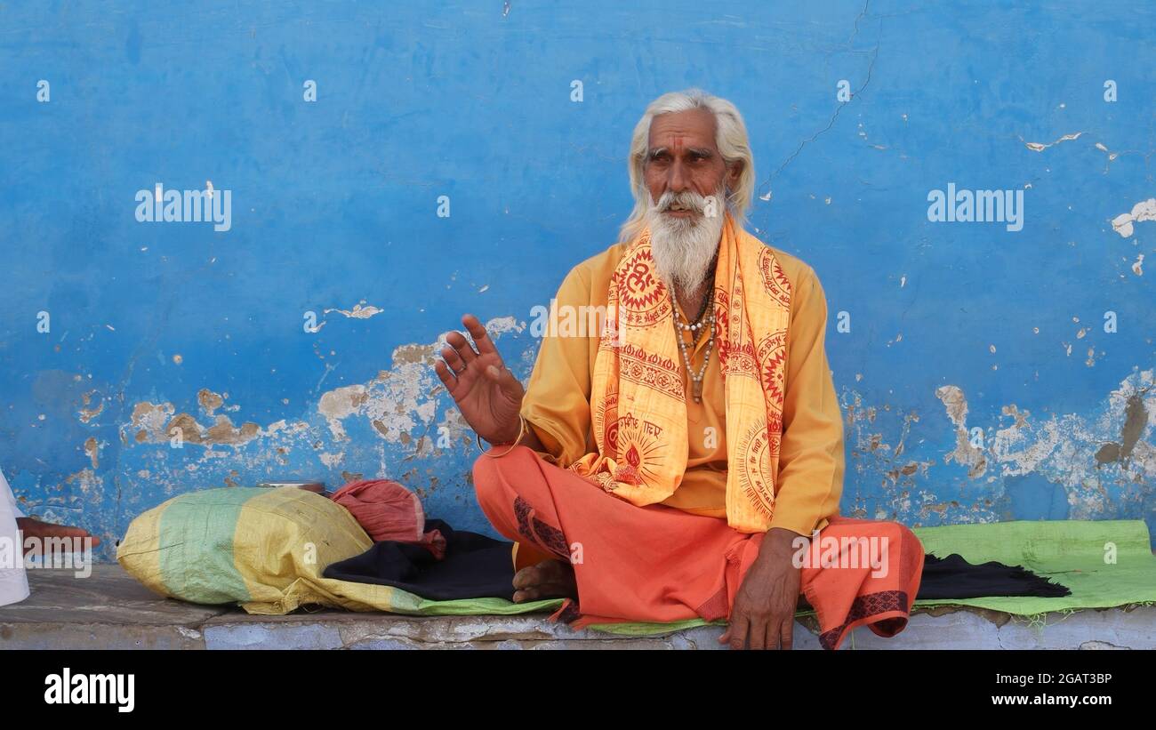 An old Indian man sitting on the ground and meditating Stock Photo - Alamy